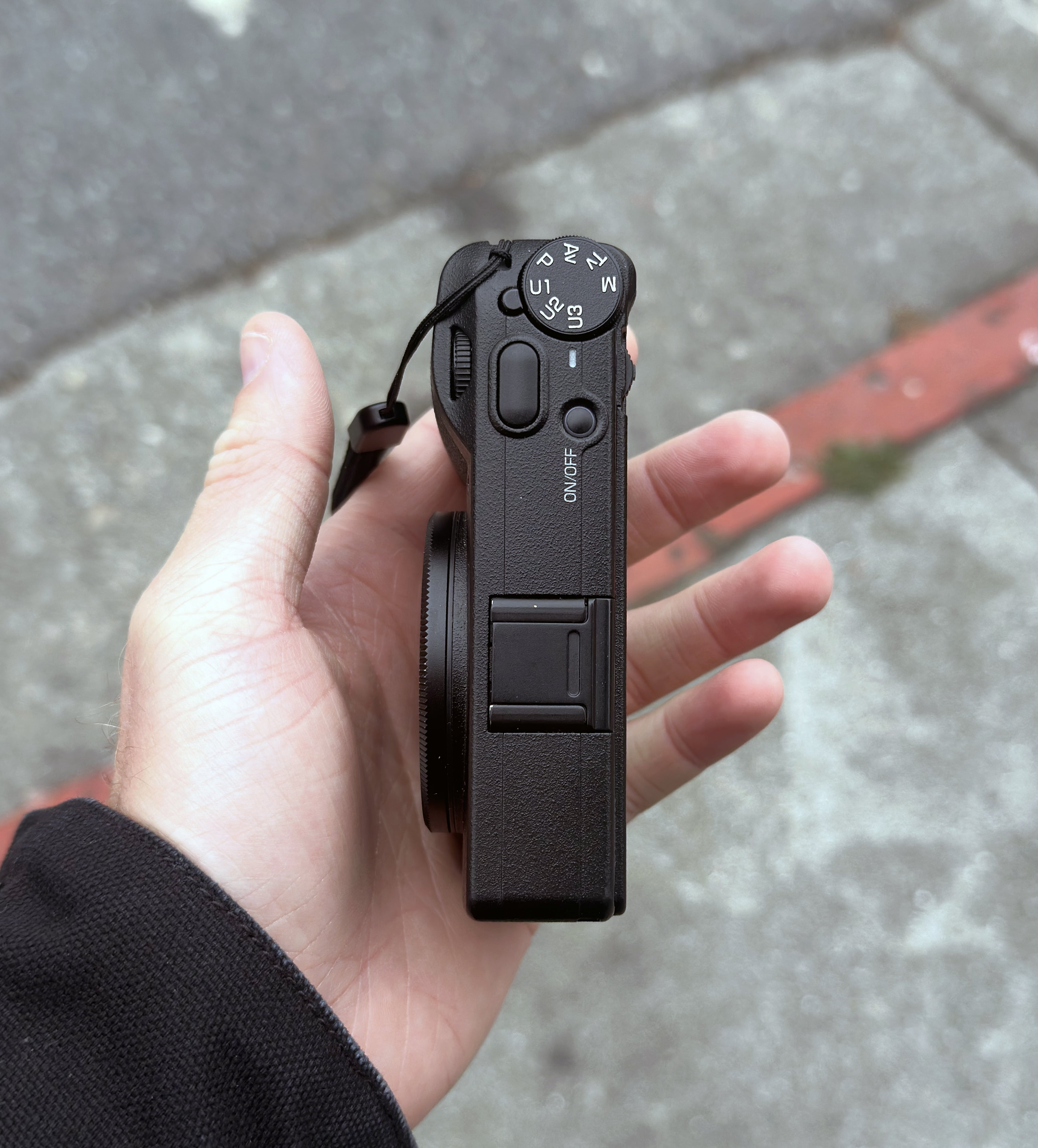 A closeup shot of the Ricoh GR III showing its small size